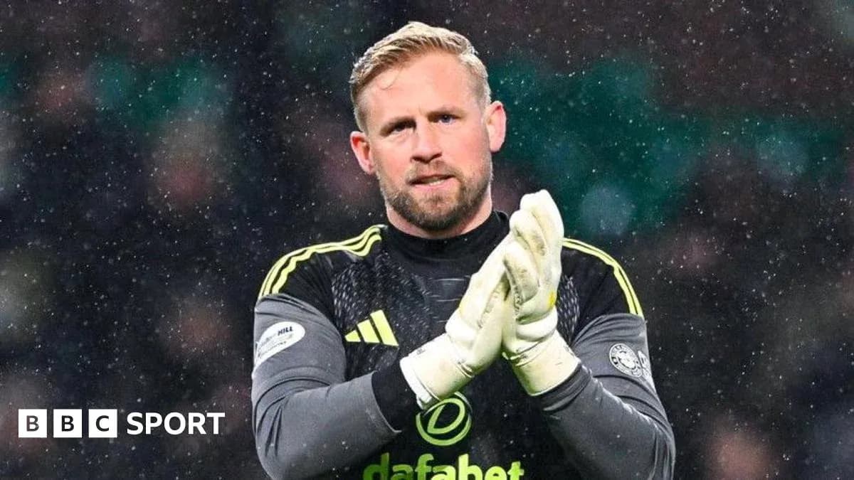 Goalkeeper clapping in snowy stadium environment