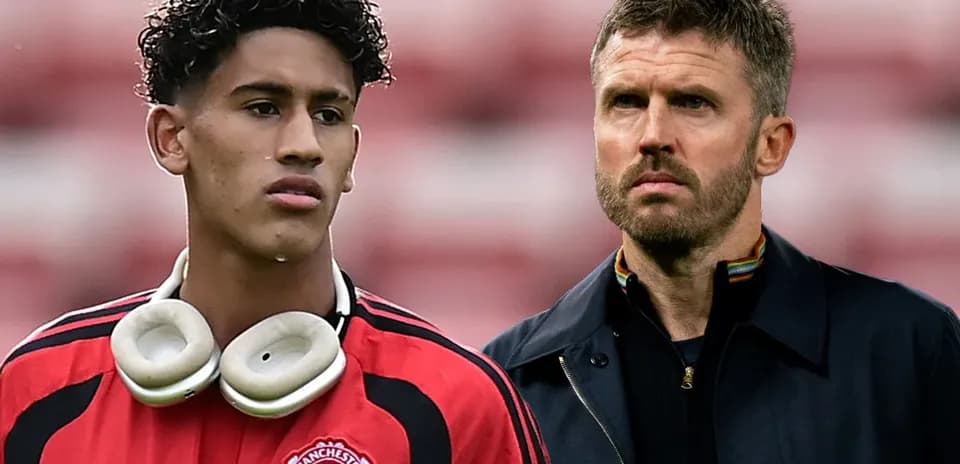 Young player in Manchester United kit with coach