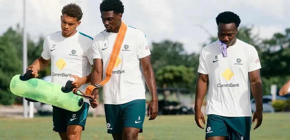 Three Australian players walking during training session