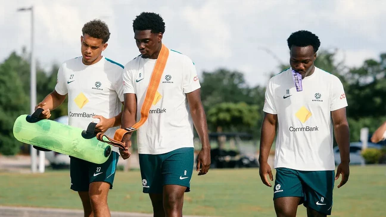 Three Australian players walking during training session
