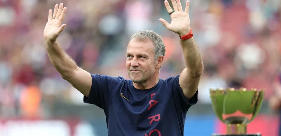 Coach waving during trophy celebration on field