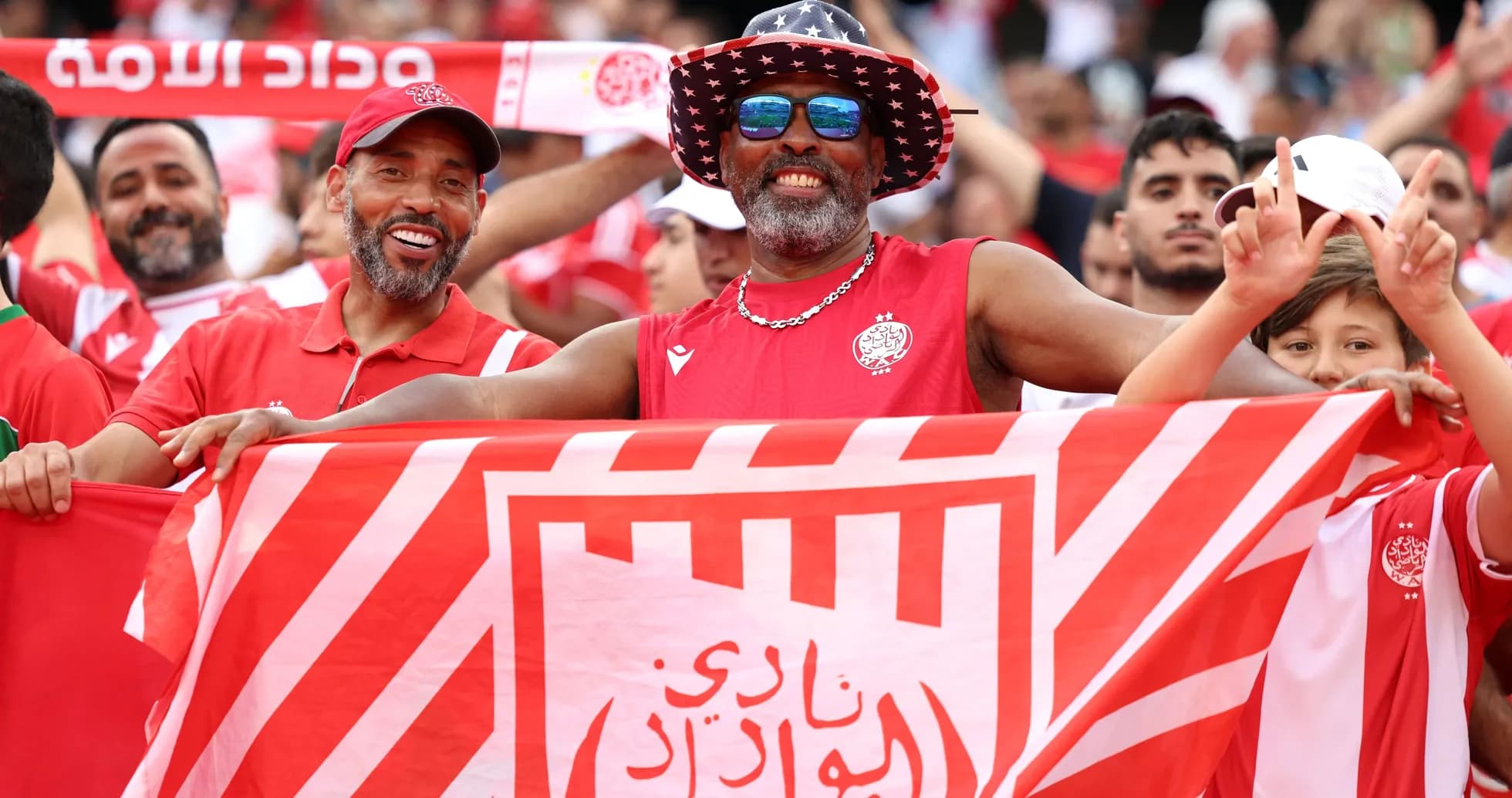 Fans celebrating with a club flag at stadium
