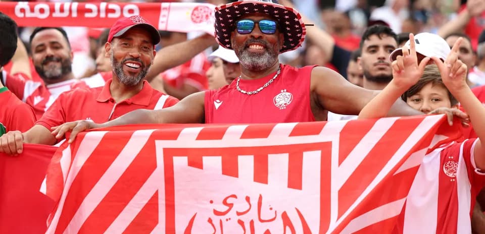 Fans celebrating with a club flag at stadium