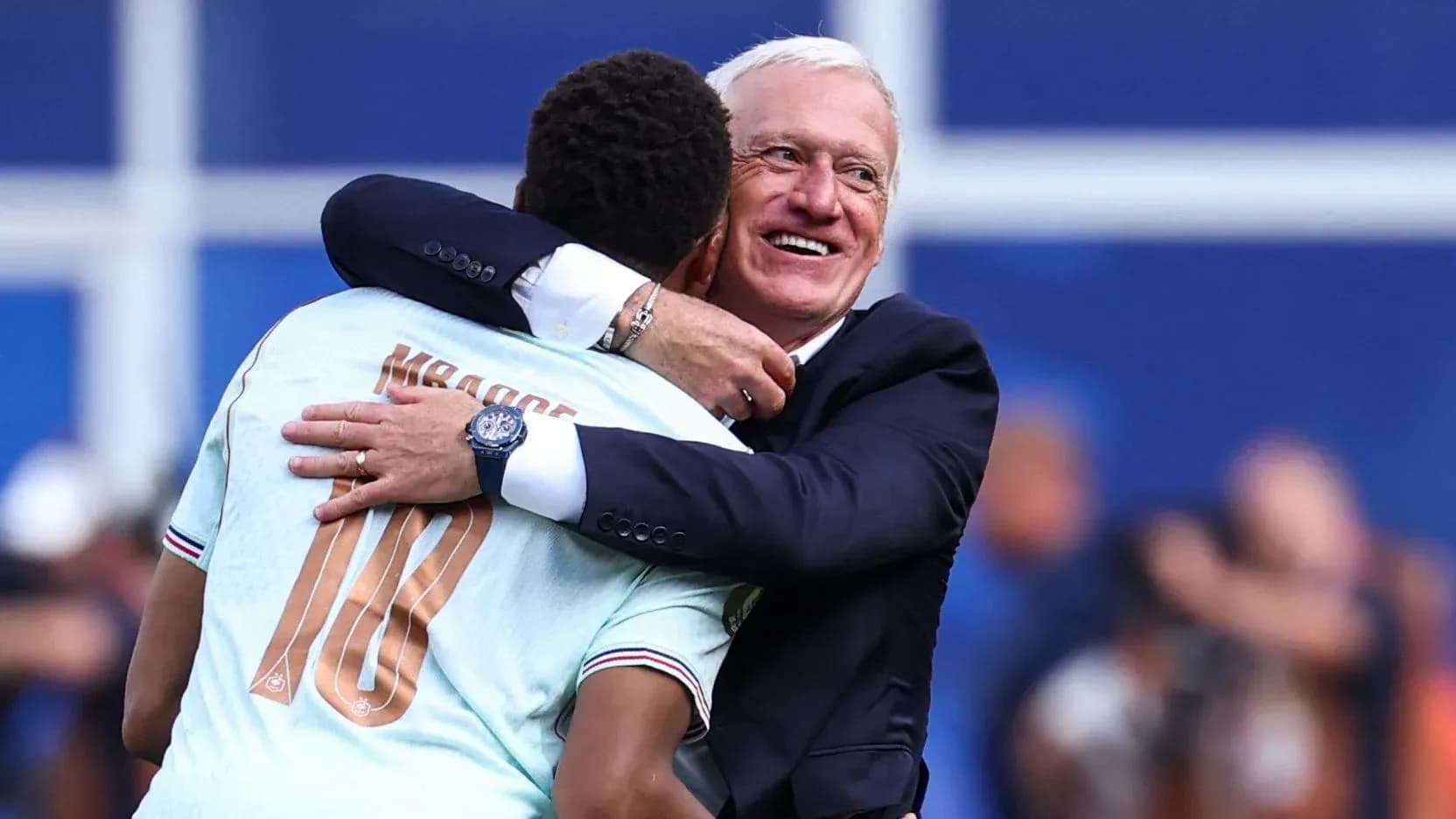 Player and coach embracing after a match