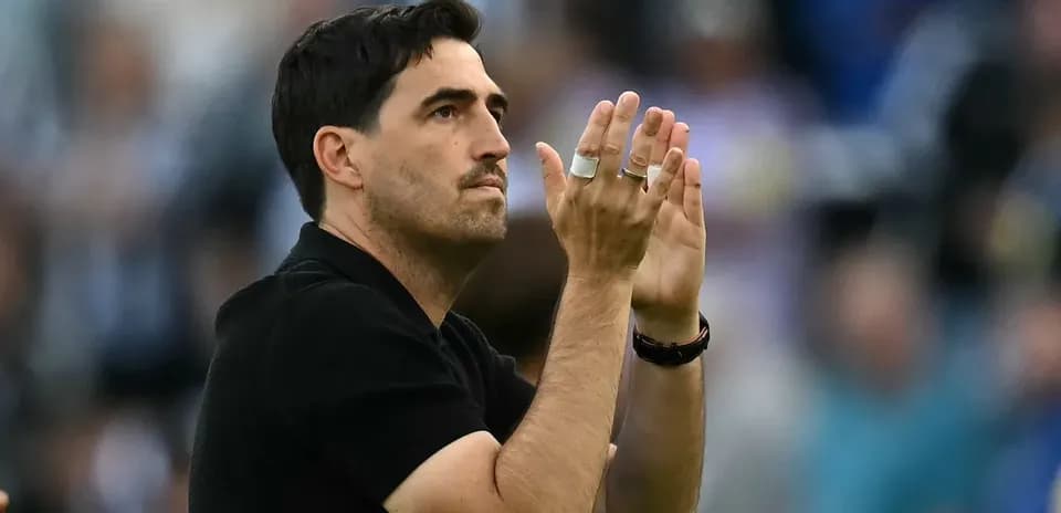 Coach applauding the crowd during match