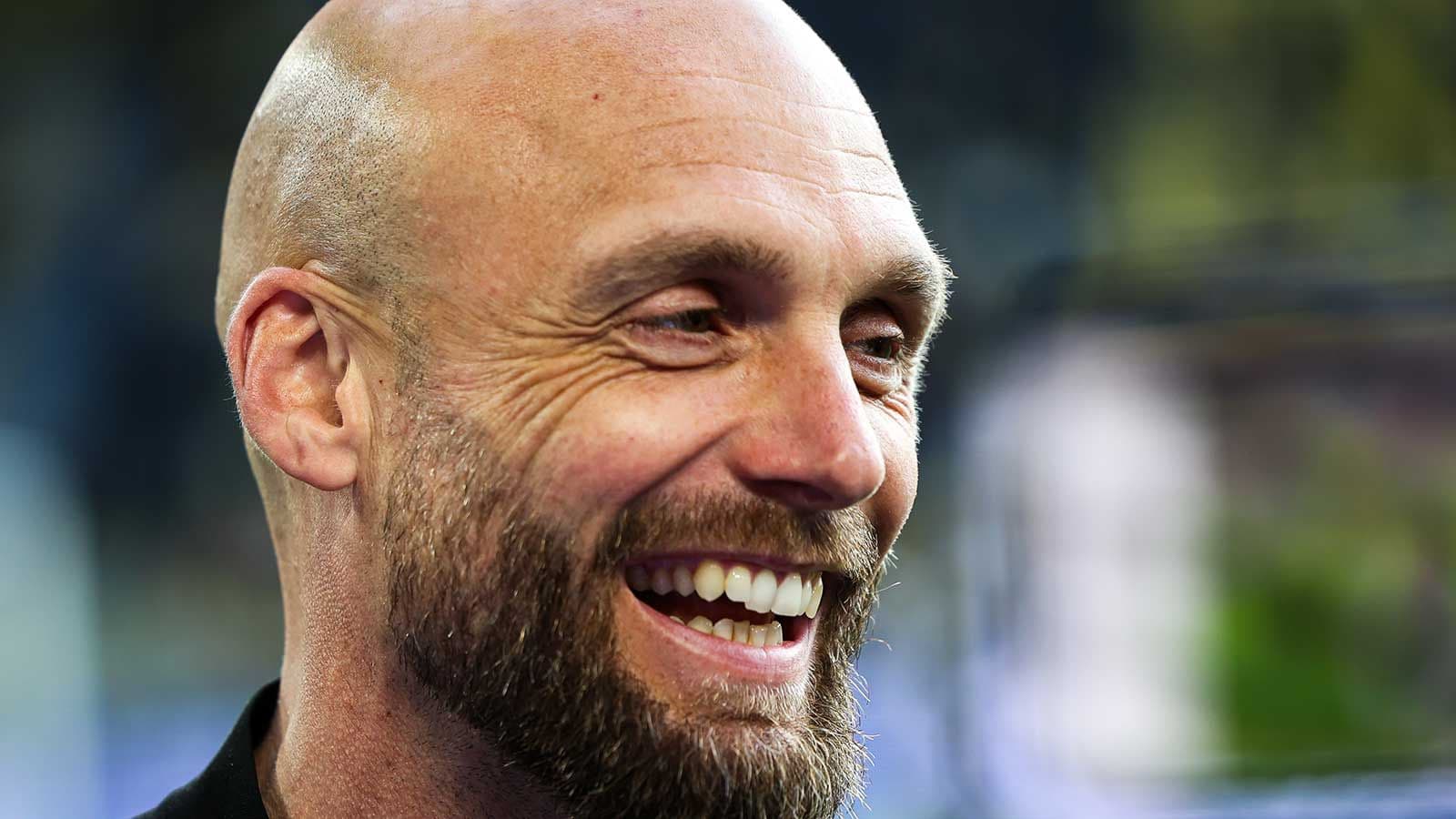 Smiling man with a beard during an event