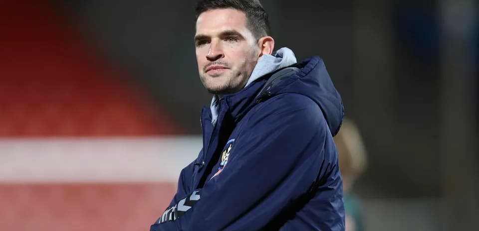 Coach observing from the sidelines during a match