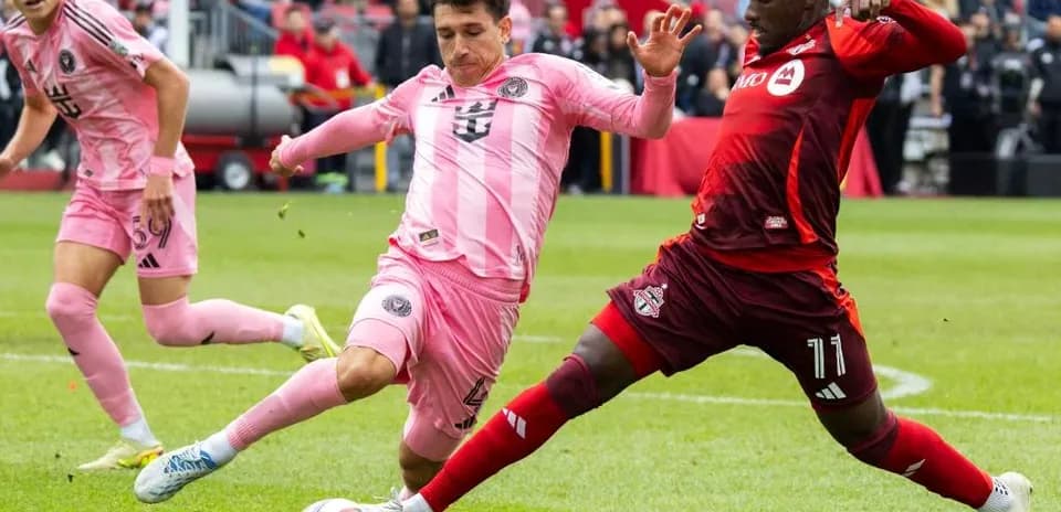 Inter Miami players challenging Toronto FC in match
