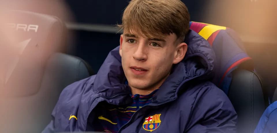 Barcelona player sitting on the bench in jacket