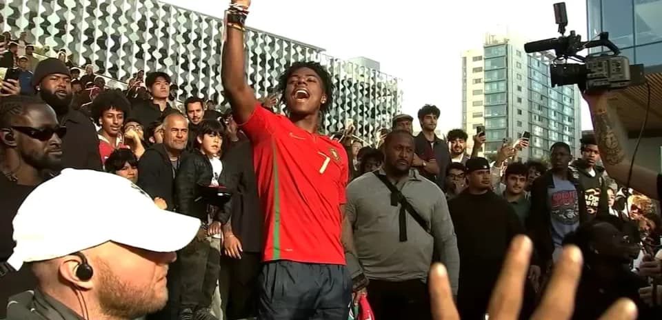 Fan in Portugal jersey celebrating among crowd