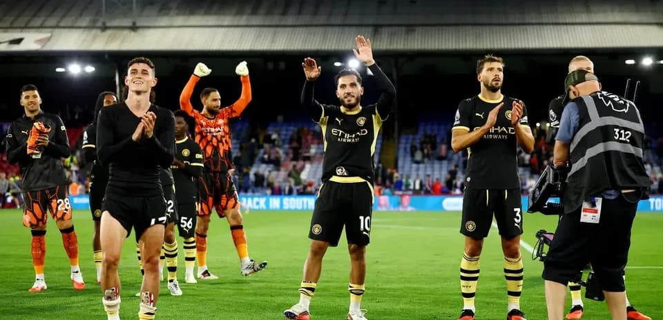 Players celebrating and applauding fans after match