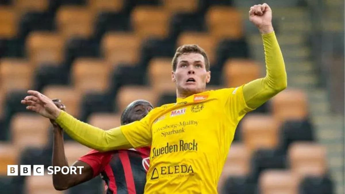 Player in yellow jersey competing for the ball