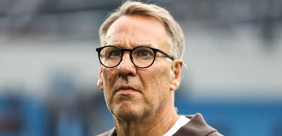 Man with glasses looking thoughtfully during event