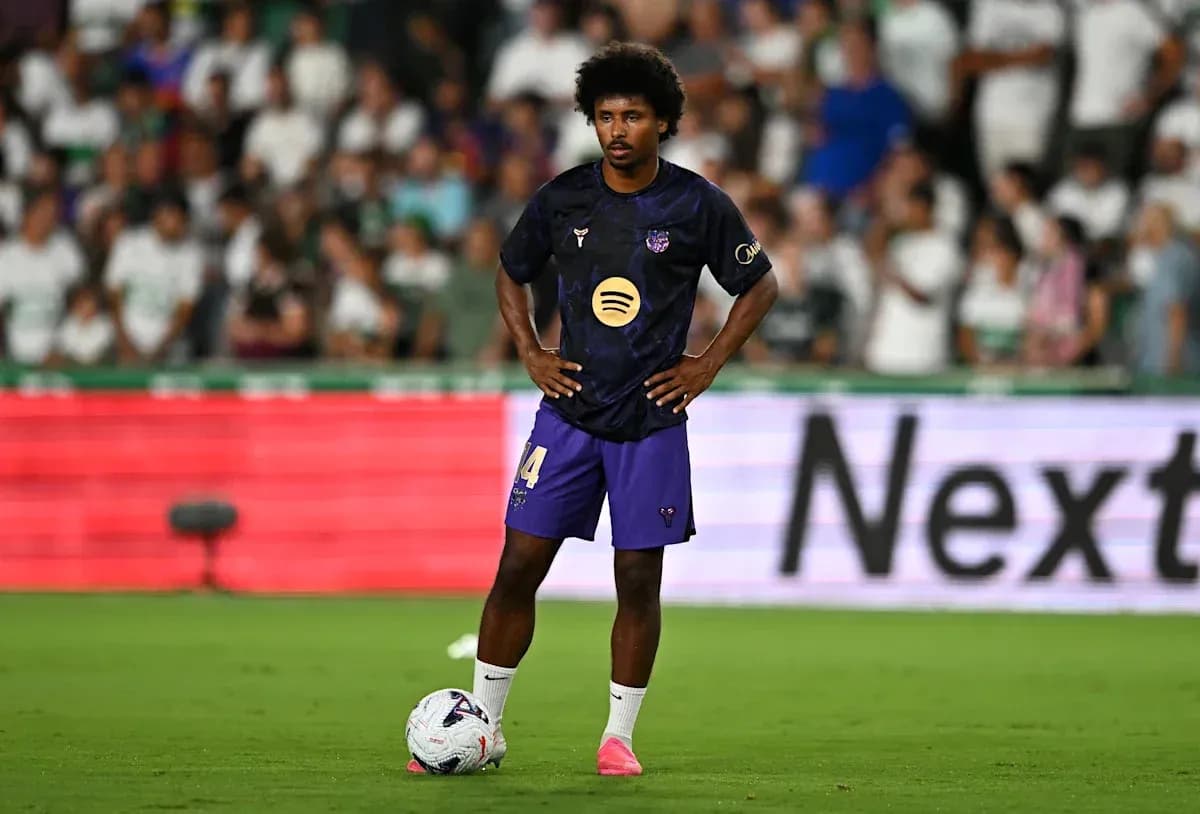 Player standing with ball during match preparation