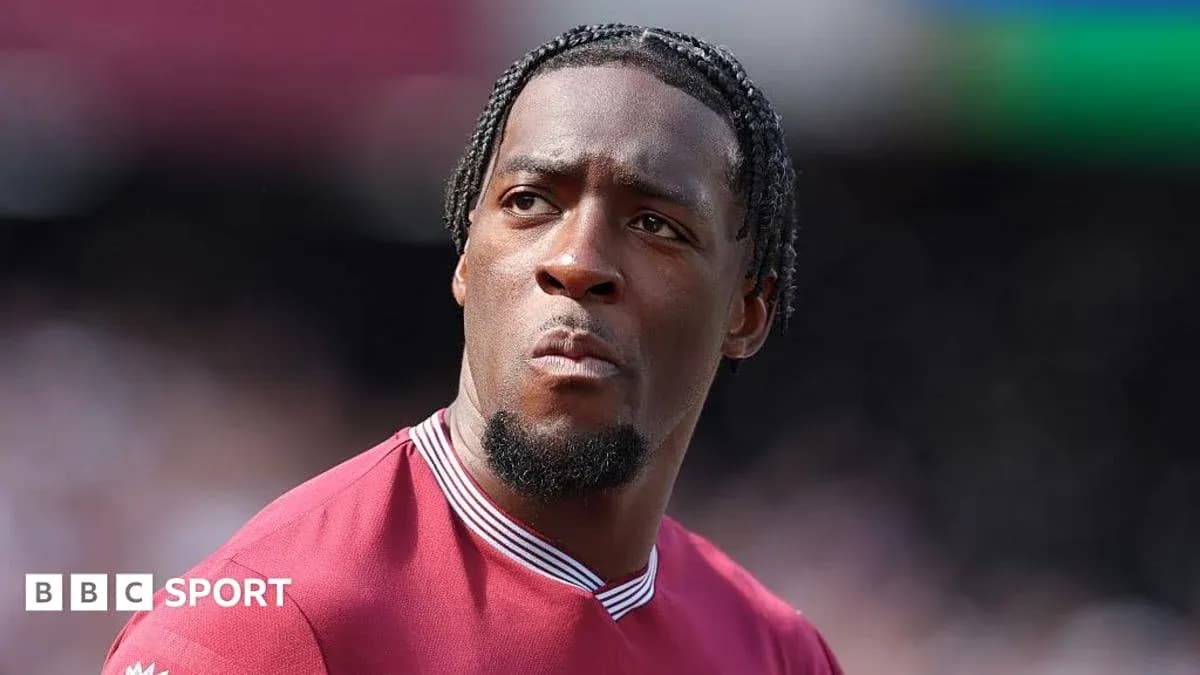 Player in maroon jersey looking focused on field