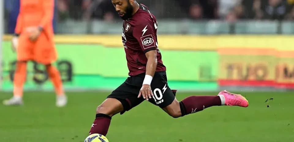 Player striking the ball during a football match