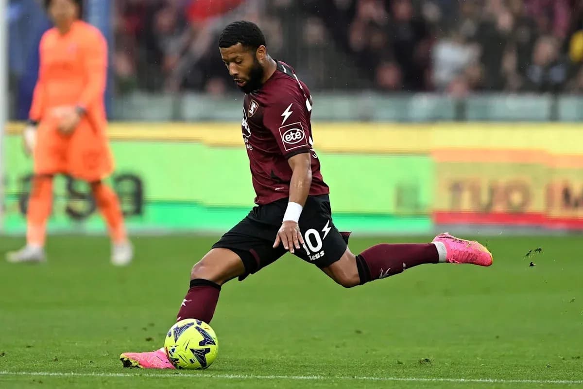 Player striking the ball during a football match