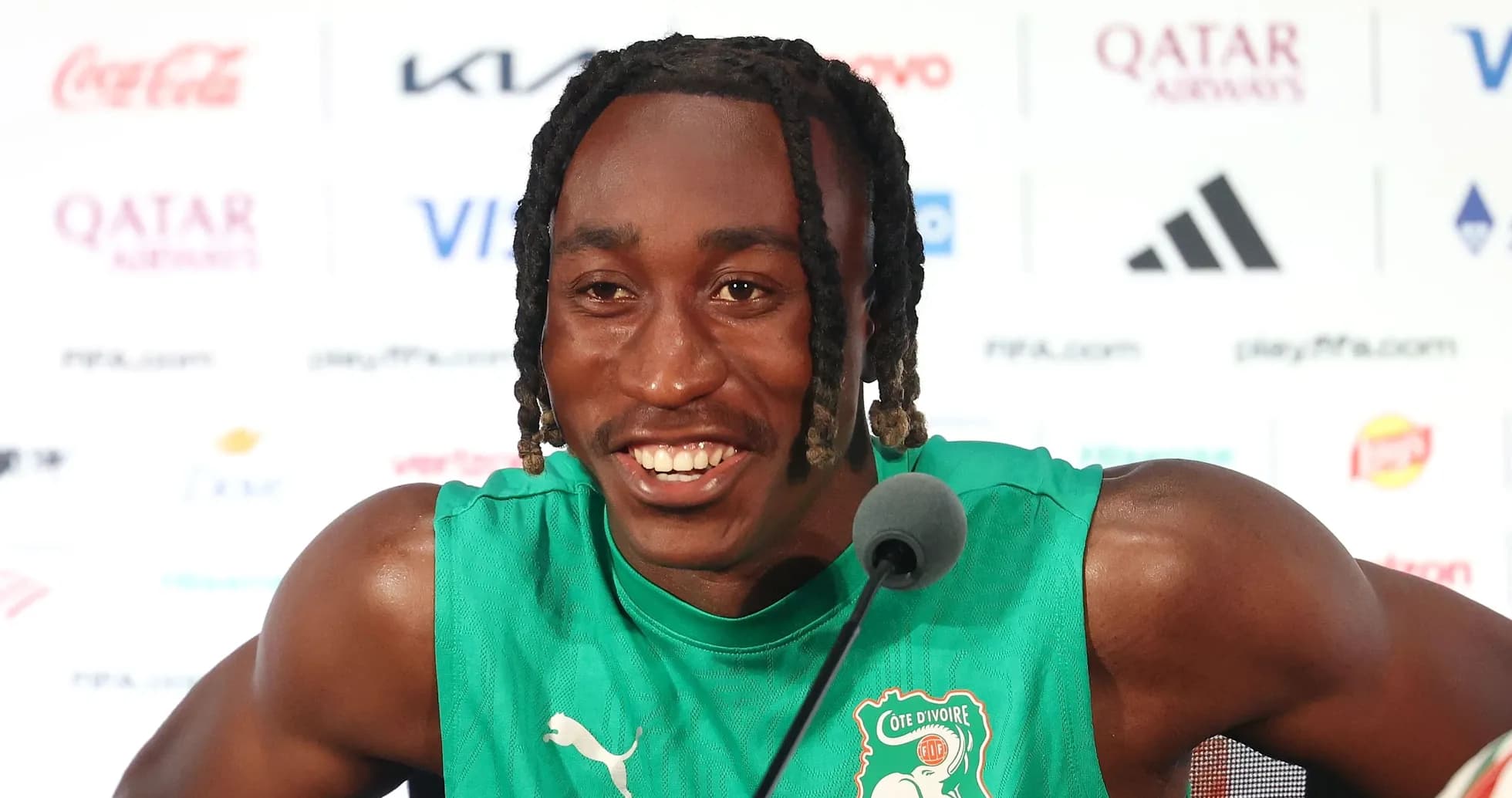 Player speaking at press conference in team jersey