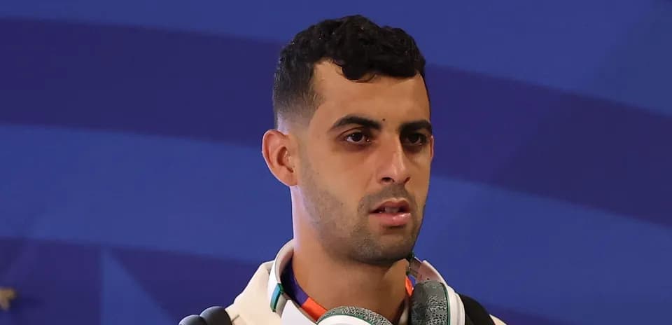 Player wearing headphones at event entrance
