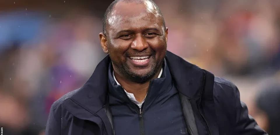 Smiling coach on the sidelines during match