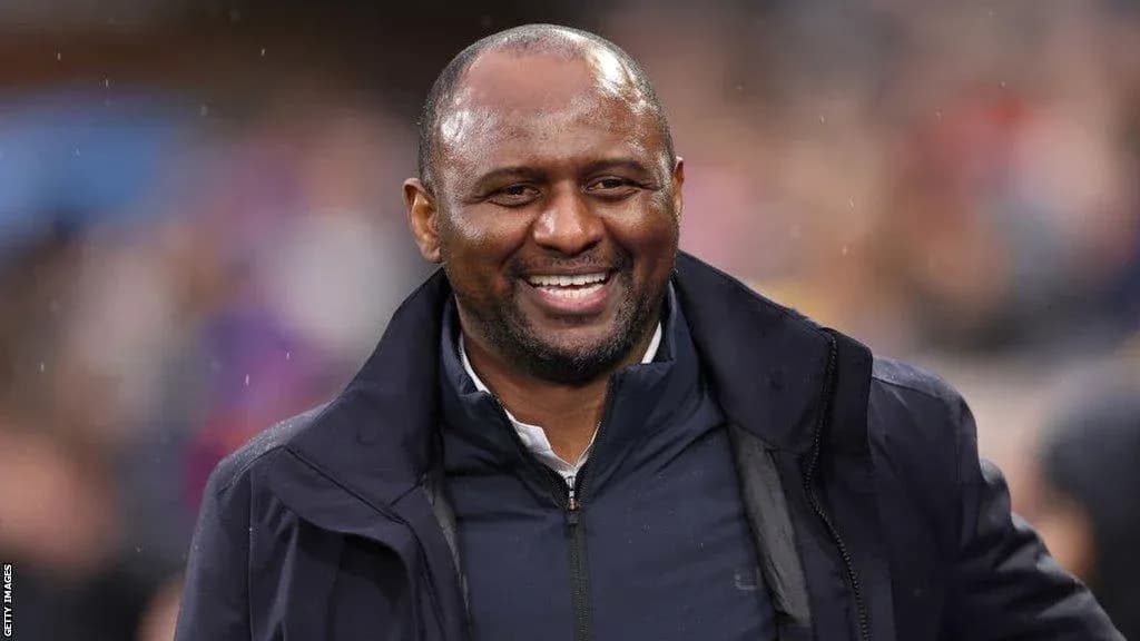 Smiling coach on the sidelines during match