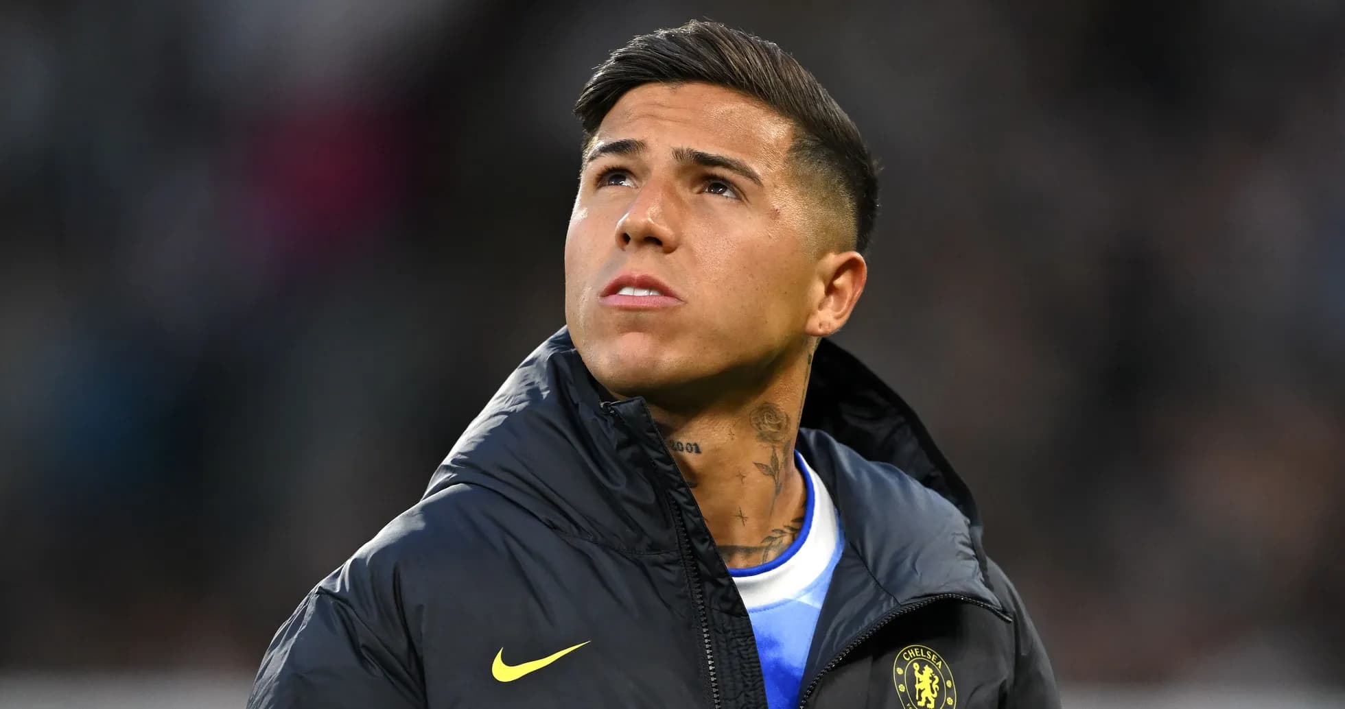 Player looking up while wearing a Chelsea jacket