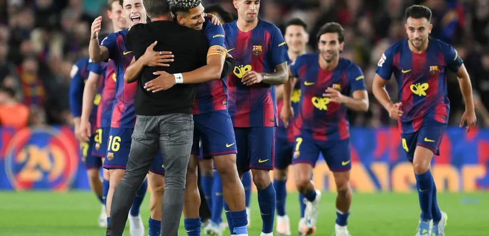 Barcelona players celebrating with manager after match