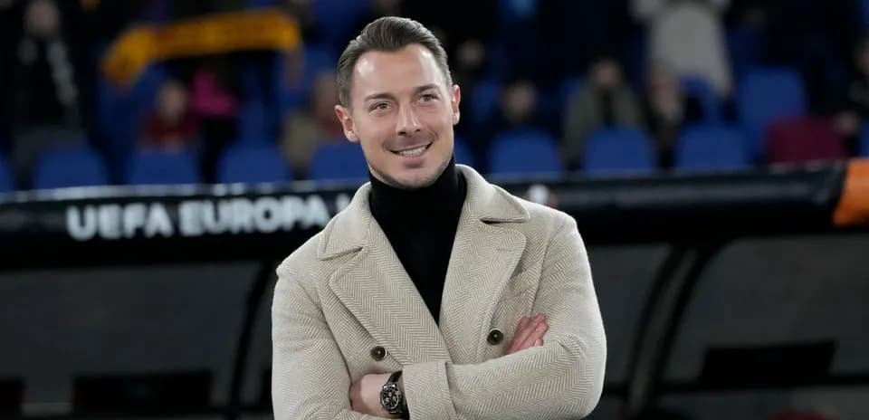 Man in stylish coat at a football match