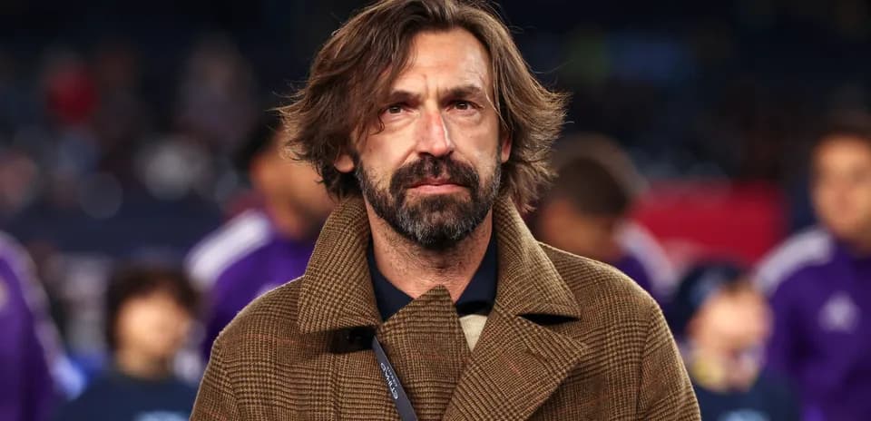 Coach in brown coat at a match event