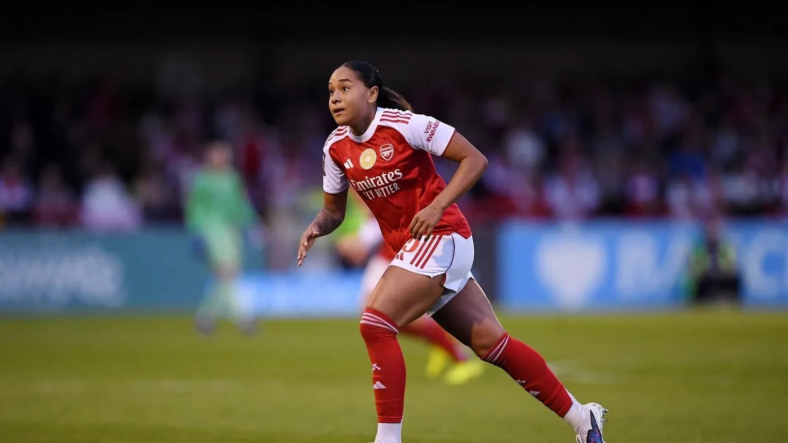 Player running on the field in Arsenal kit