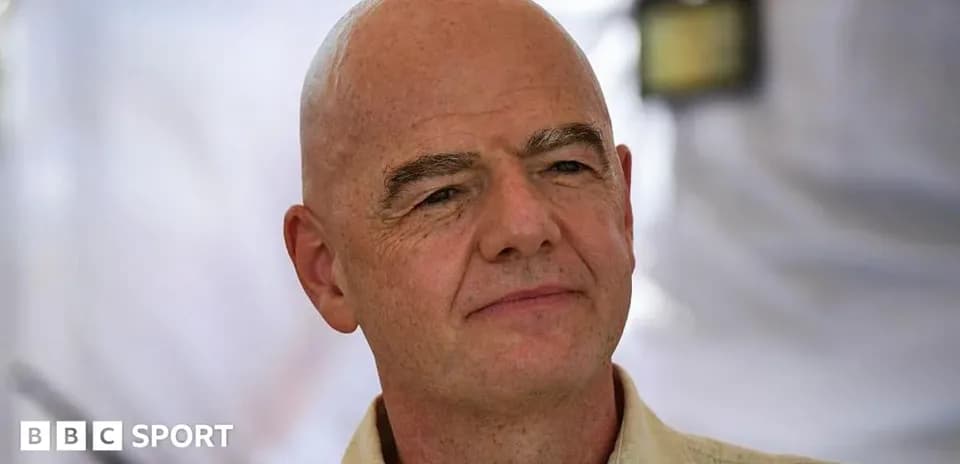 Man with bald head and light-colored shirt