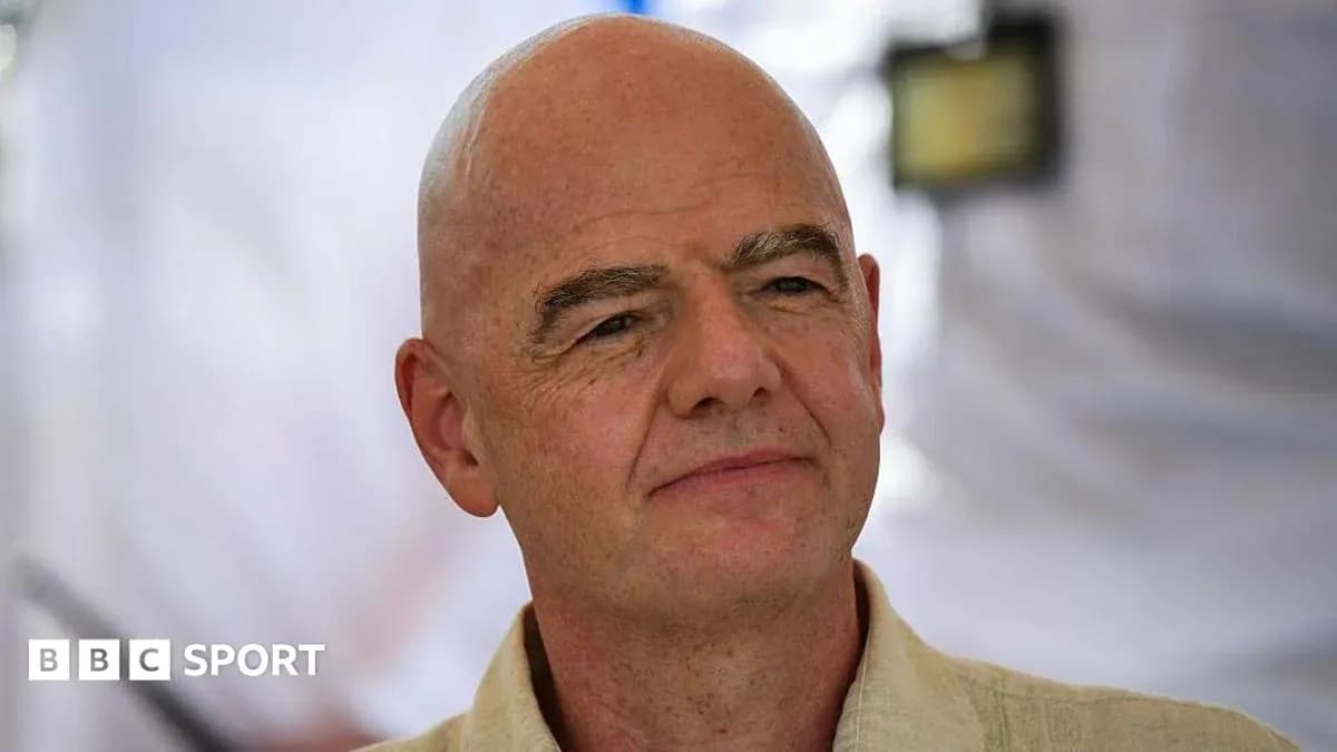 Man with bald head and light-colored shirt