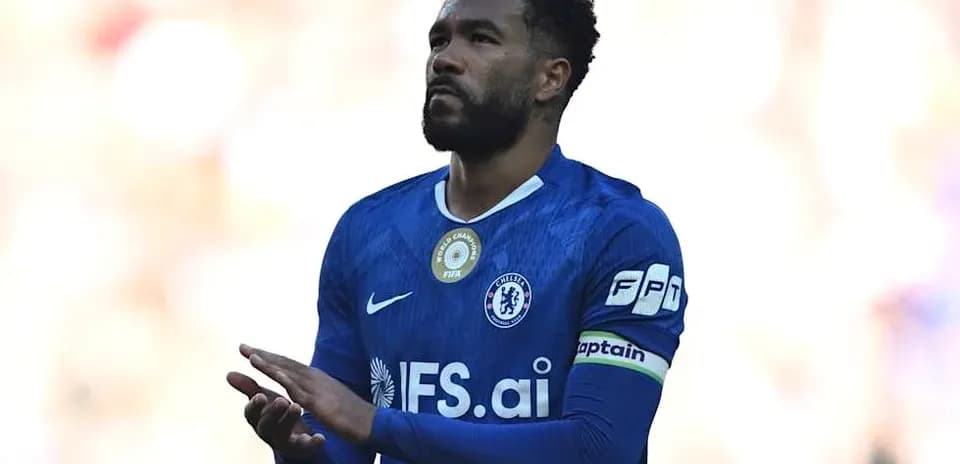 Player in blue jersey with captain's armband on field