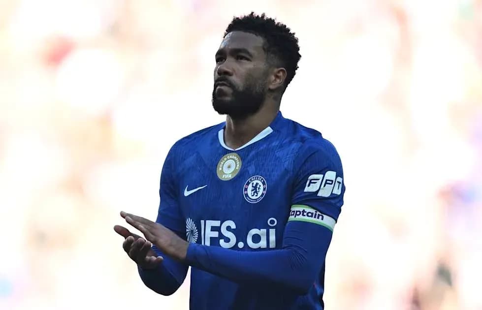 Player in blue jersey with captain's armband on field