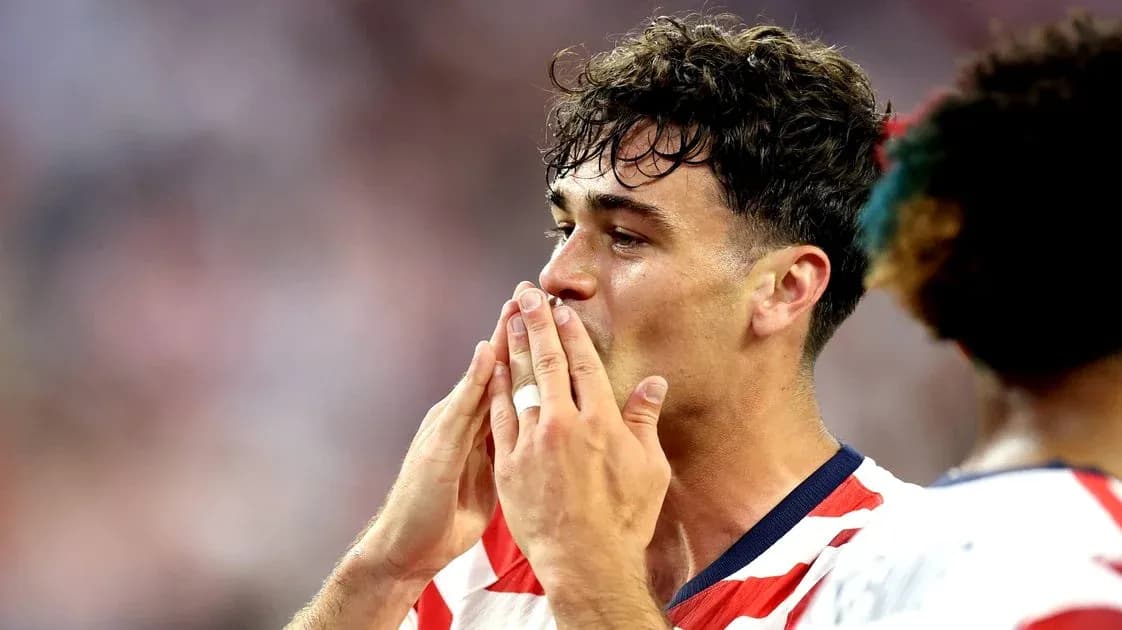 Player gesturing to fans during match celebration