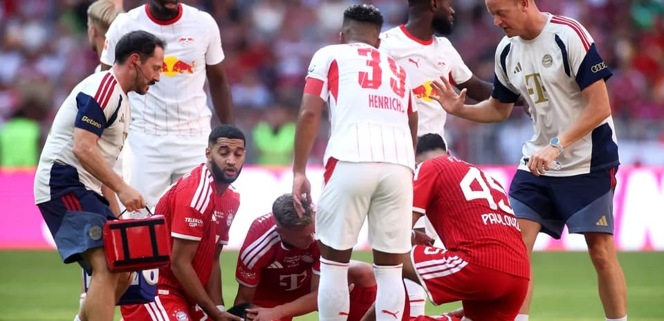 Players attending to injured teammate on the field