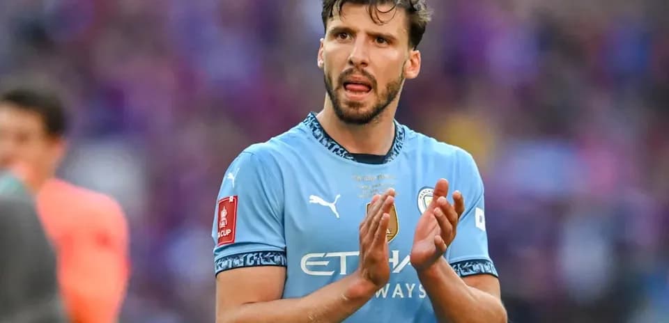 Player clapping in Manchester City kit on pitch