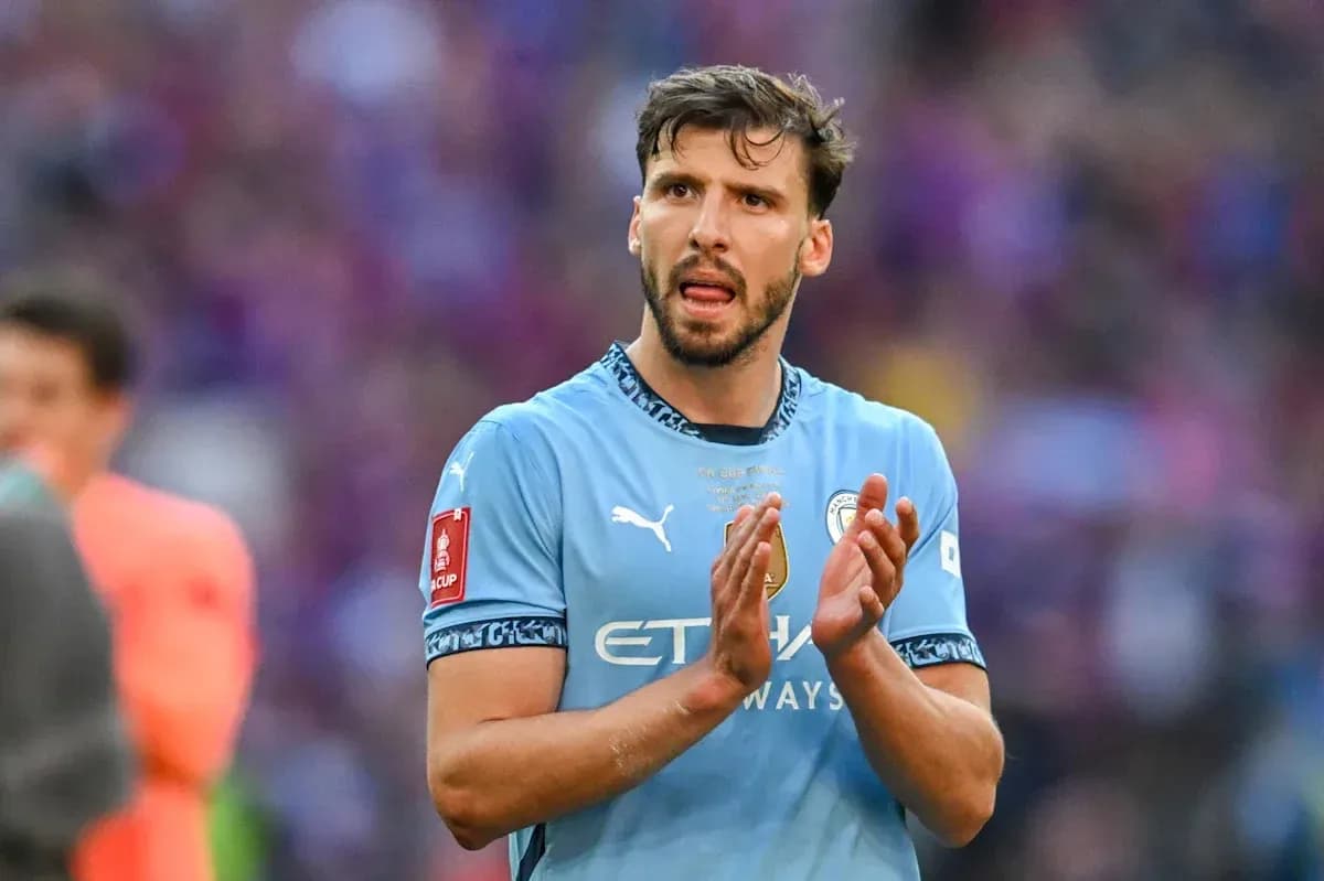 Player clapping in Manchester City kit on pitch
