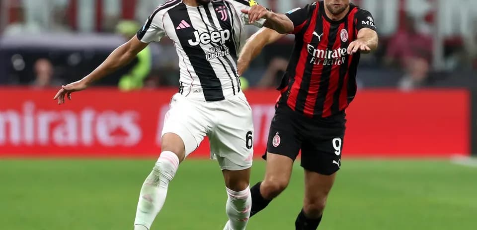 Juventus player challenged by AC Milan opponent