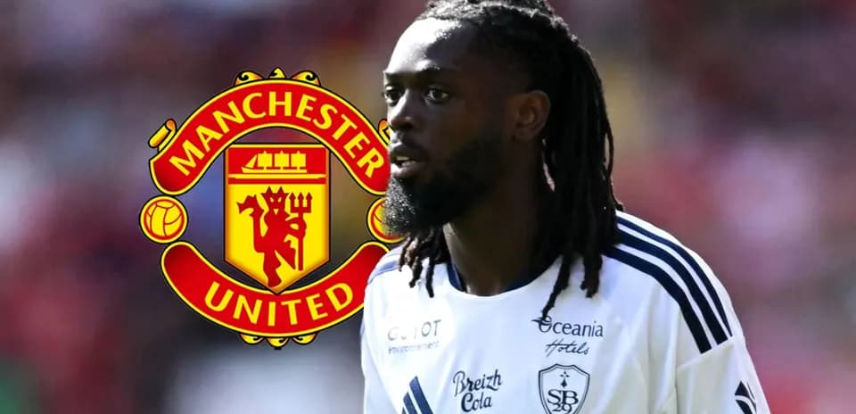 Player walking with Manchester United logo in background