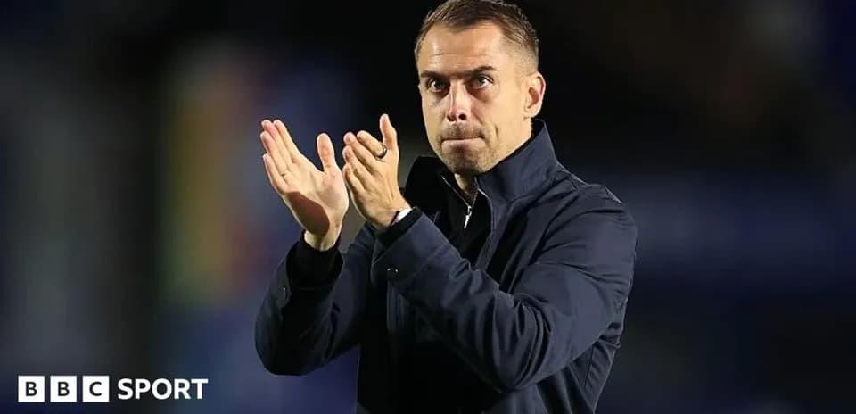 Coach applauding fans during a match