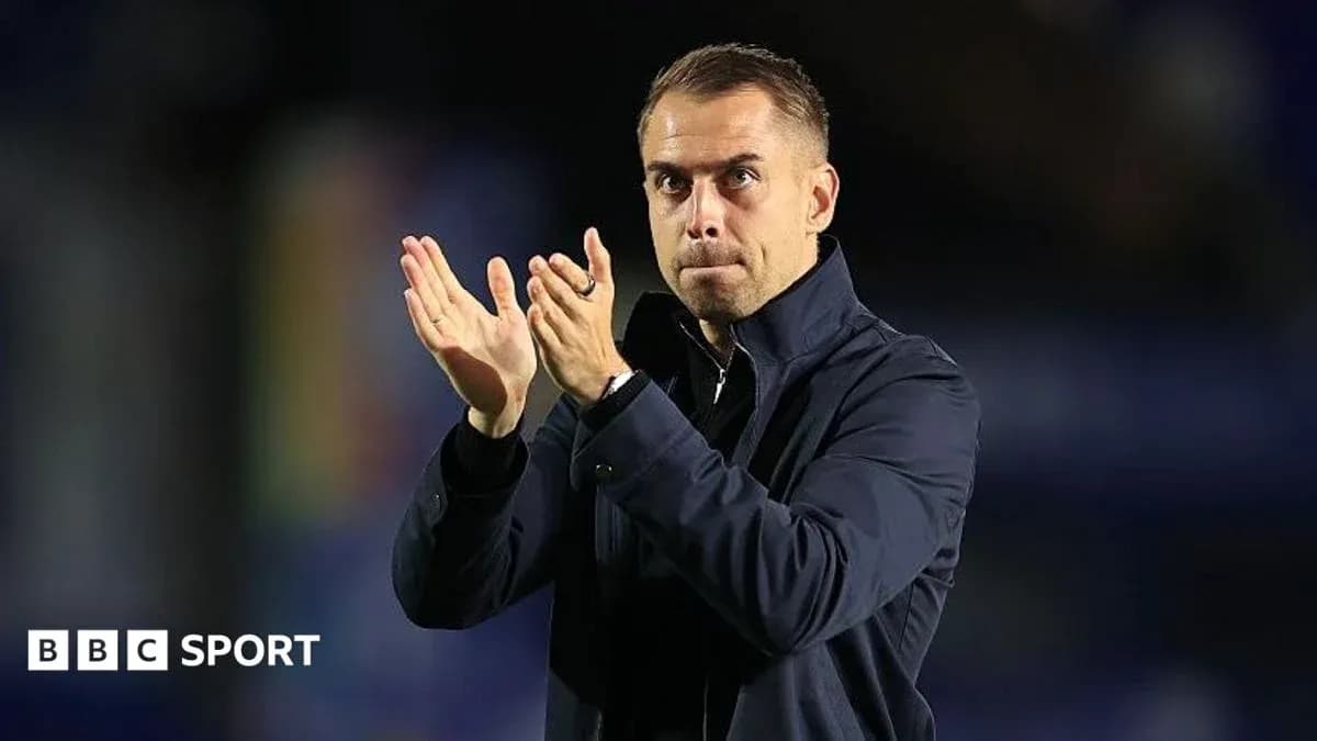 Coach applauding fans during a match