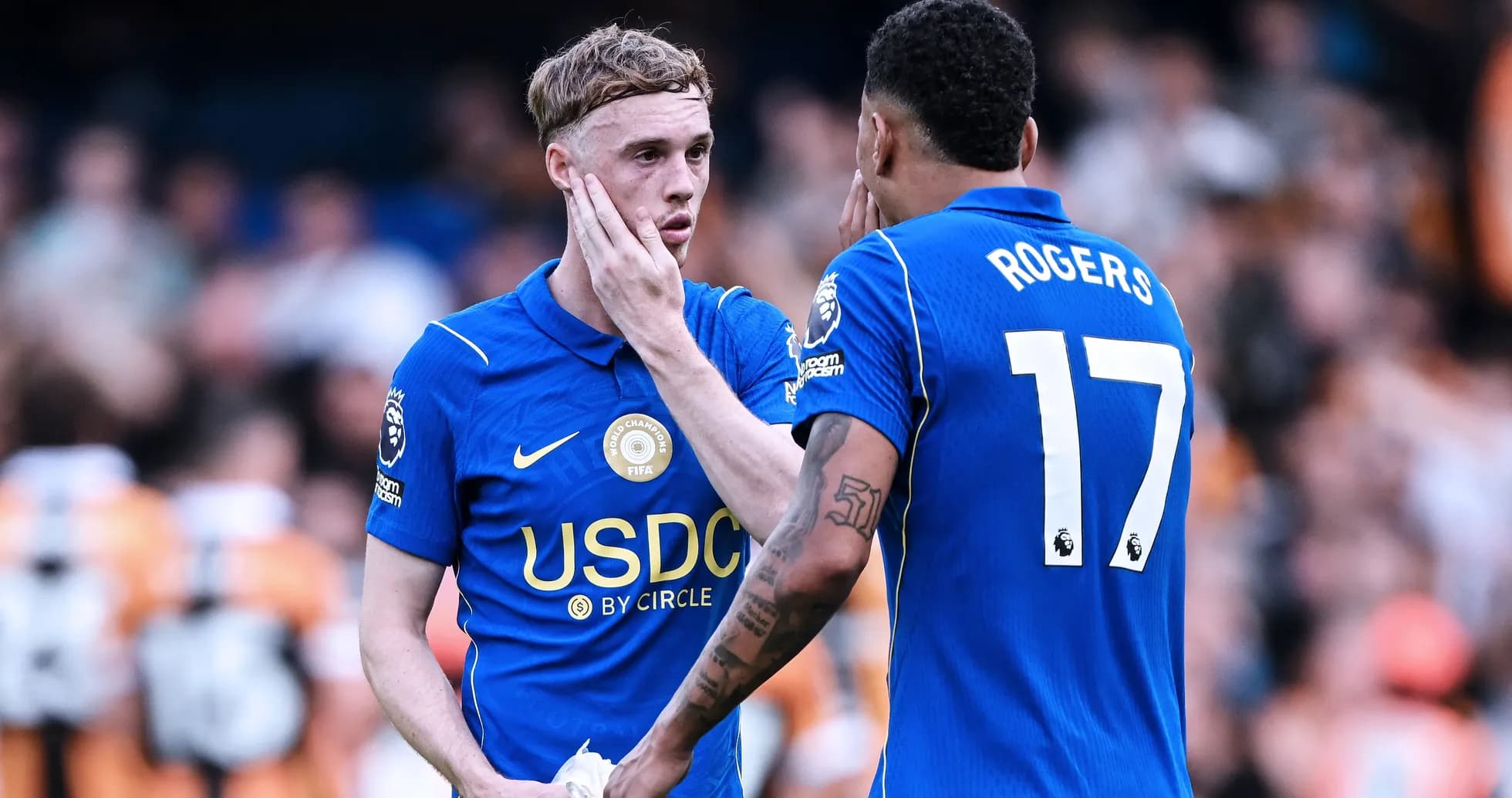 Two players discussing on the pitch during match