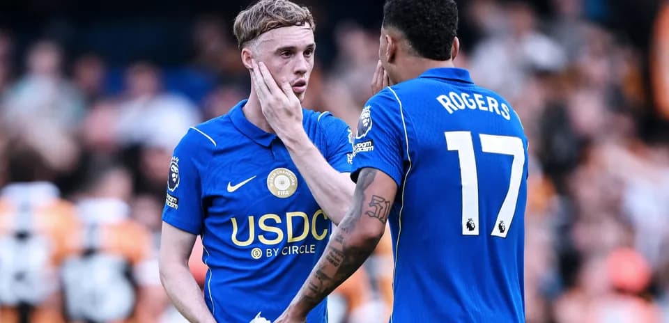 Two players discussing on the pitch during match