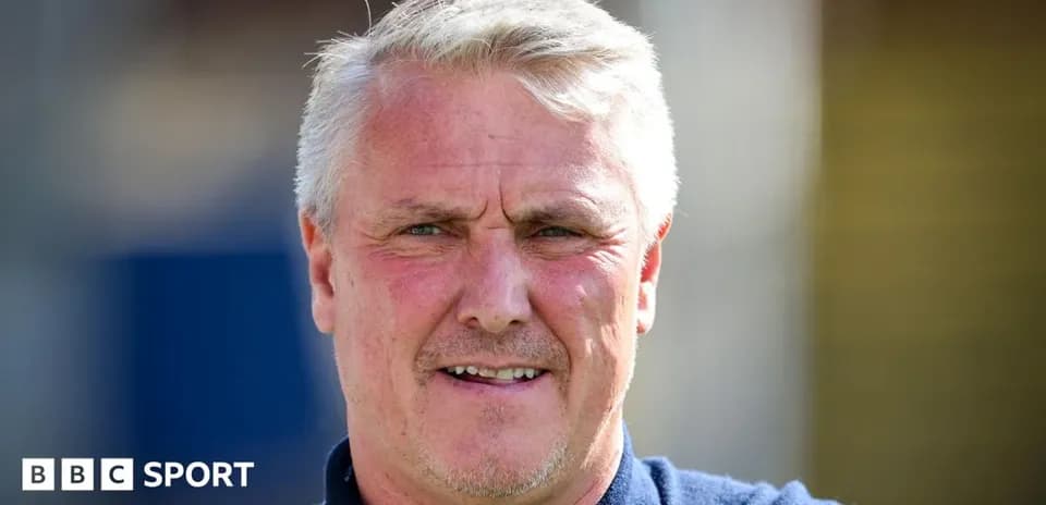 Coach posing for photo at training facility