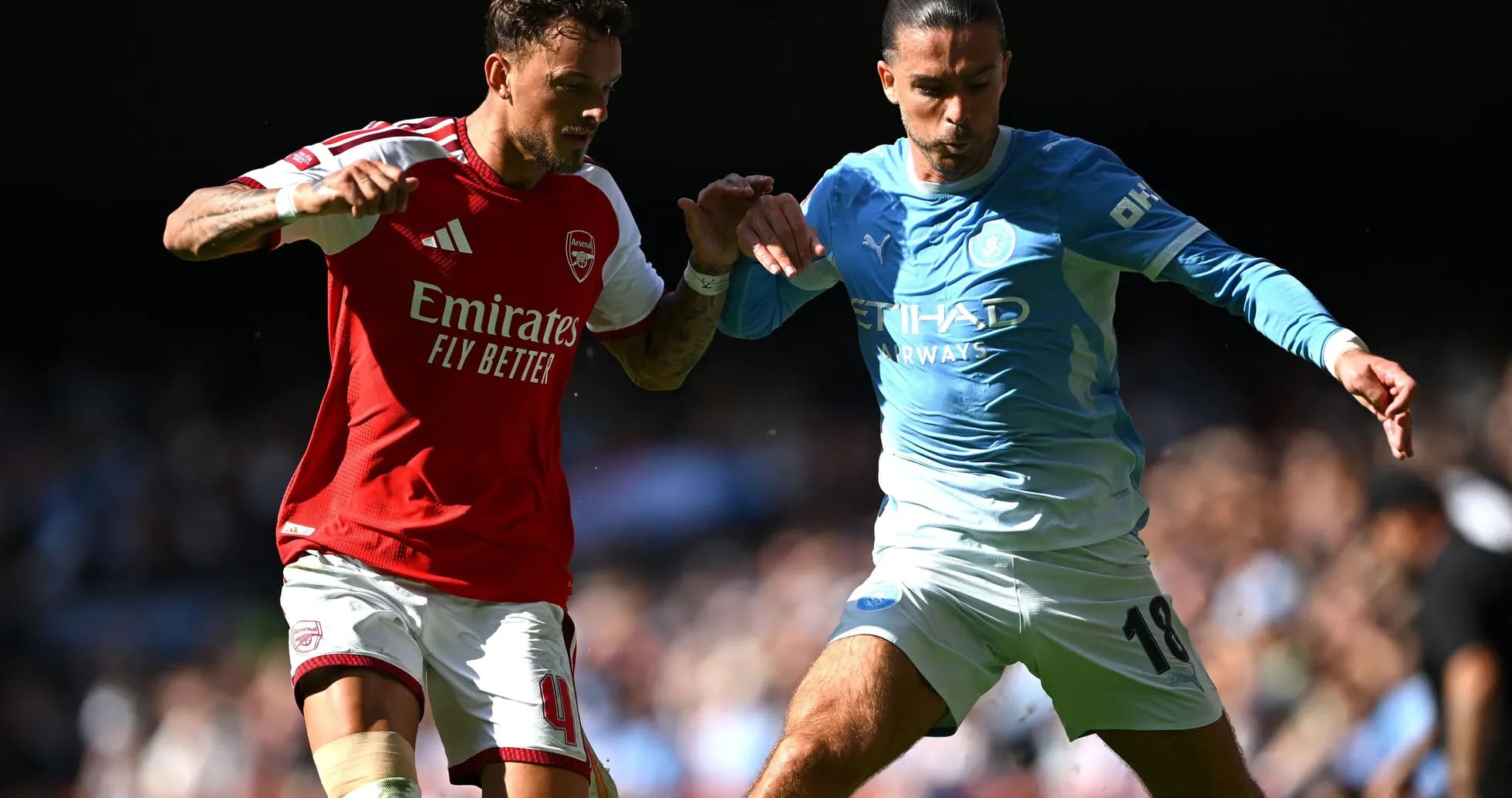 Arsenal and Manchester City players contesting the ball