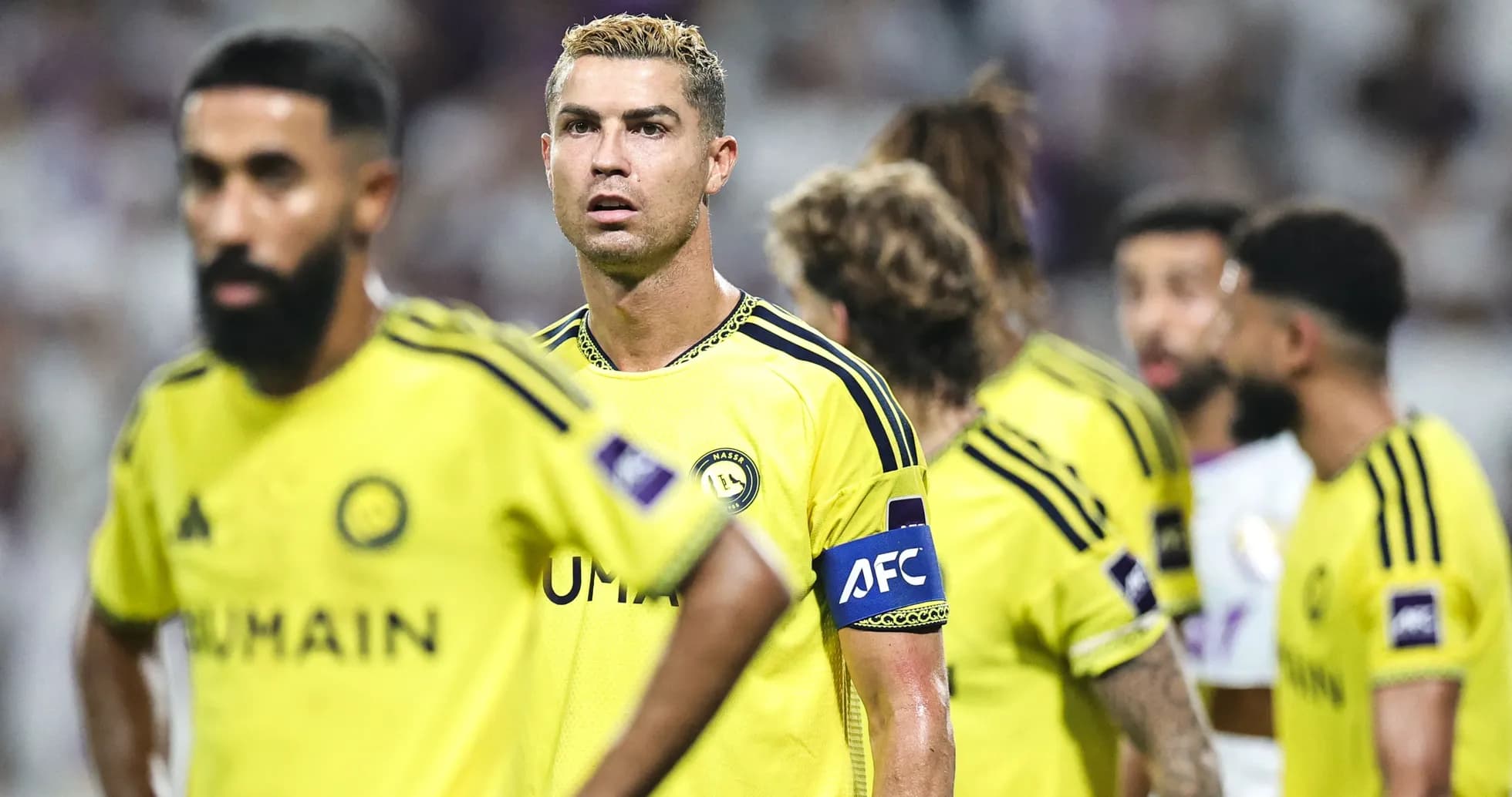 Players in yellow uniforms during a football match