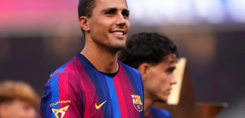 Player smiling during trophy celebration ceremony