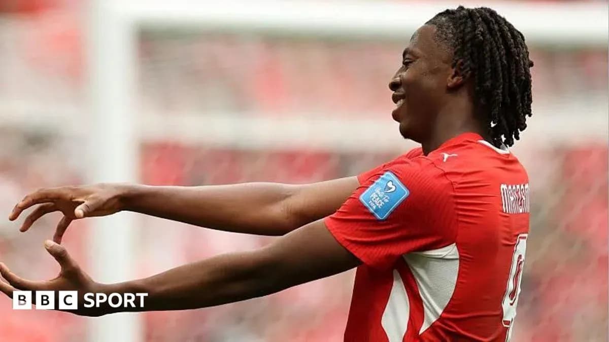 Player celebrating during a match in red jersey