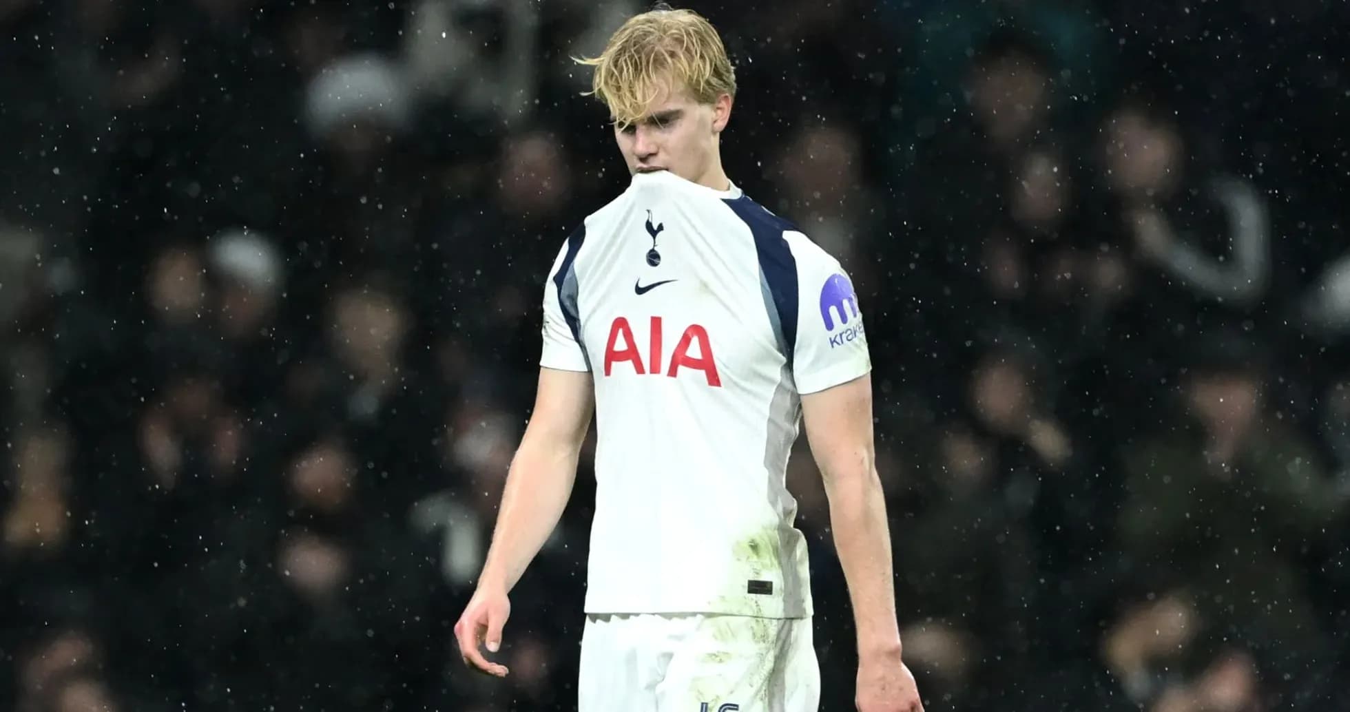 Tottenham player looking down during match in rain